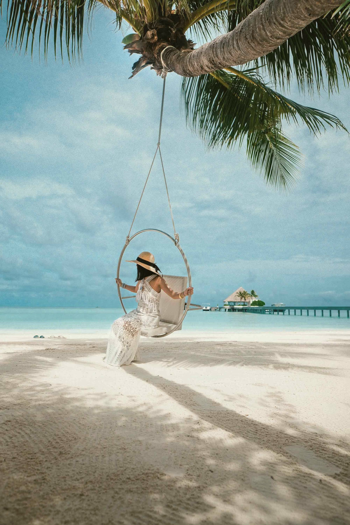A swing over clear water in the Maldives
